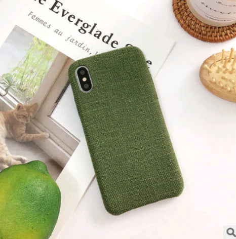 Green textured phone case on a surface with a cat and lemon in the background